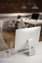 Computer and cup of tea on table