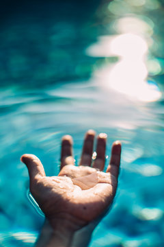 A man's hand on the water