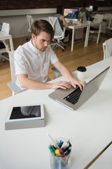Fototapeta na wymiar Executive using laptop in office