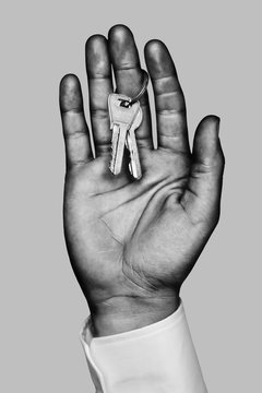 Business hand with two home keys Black and white