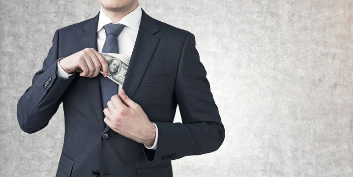 Businessman Putting Money In A Pocket