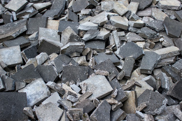 Heap of unarranged broken old pavement tiles.