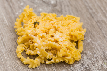 raw egg pasta over wooden background