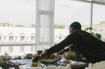 Girl delivering the thanksgiving Turkey to the table