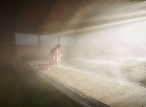 Woman relaxing at hot water spring in spa