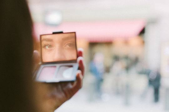 Woman looking at camera through a mirror