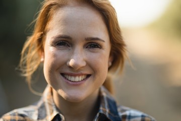 Fototapeta premium Portrait of smiling young woman at farm 
