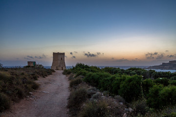 Fototapeta na wymiar Ghajn Tuffieha Tower in Golden Bay at sunset - Malta