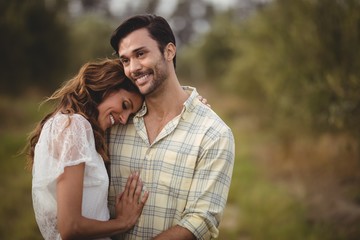 Young couple embracing at olive farm