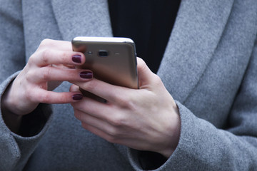 Social Media addiction. young beautiful woman holding a smartphone (psychological problems, media mania)