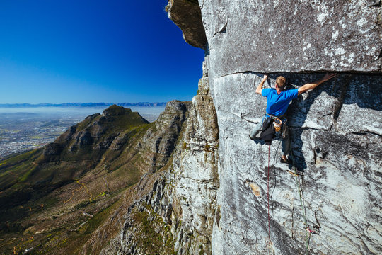 Rock climber on a sheer cliff face