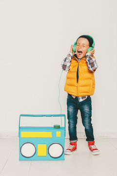 Little hipster boy with diy colored radio singing 
