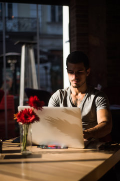 Man using a laptop in a cafe 