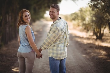 Young couple holding hands while walking 