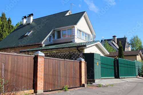 Modern brick countryside houses with a fence. Eastern Europe, Russia ... Modern brick countryside houses with a fence. Eastern Europe, Russia ...