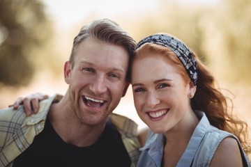 Portrait of cheerful young couple at olive farm