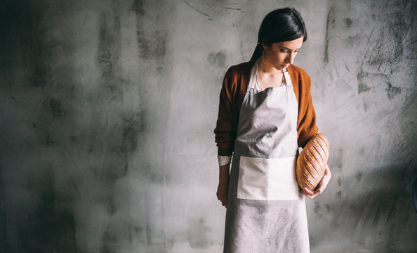 Portrait Of A Woman Baker Holding A Loaf Of Bread