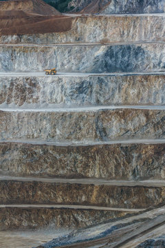 yeilow quarry truck on the road of a strip mining area