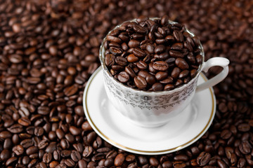 Arabica coffee beans in classic ceramic cup