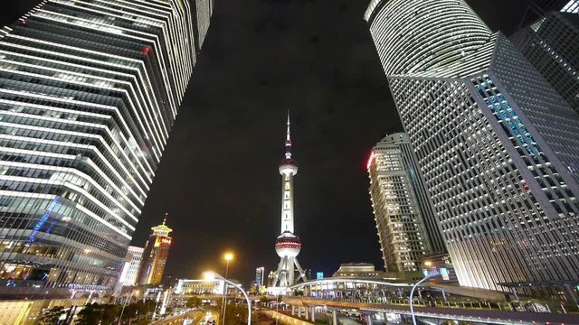 busy city traffic & brightly lit urban finance skyscraper at night,orient pearl TV tower,shanghai China,use Ultra-wide-angle lens shoot.	