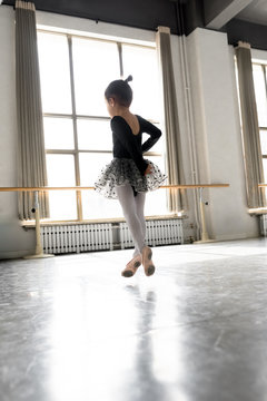 Girl practicing ballet in ballet studio