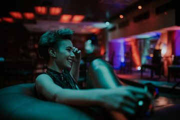 Young attractive woman smiling at the club at night