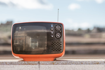 Vintage television with a sky background