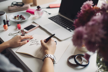 Woman Writing an Inspirational Message in Her Notebook