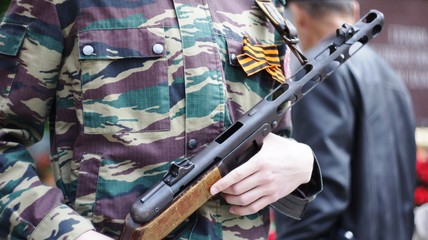 Fototapeta premium The guard of honor in the camouflage with a submachine gun 