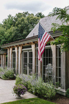 An exterior view of house with American flag