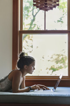 Teen Girl Using Laptop at Home