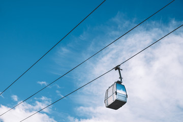 Cable car with the cloudy blue sky in the background