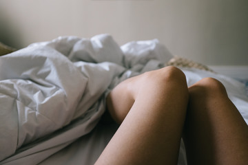 Woman's legs in bed