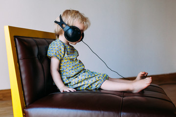 Small child wearing big headphones