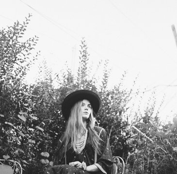 Girl in the garden wearing a '70s Moroccan dress and witches hat
