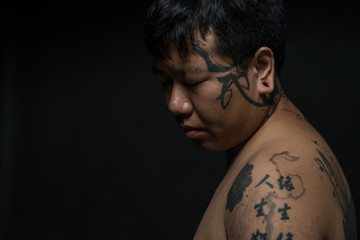 Portrait of young man with tattooed upper body
