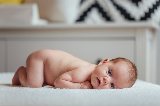 Portrait of baby boy laying on the bed