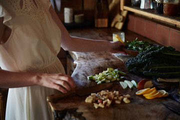 Woman cooking in rustic kitchen