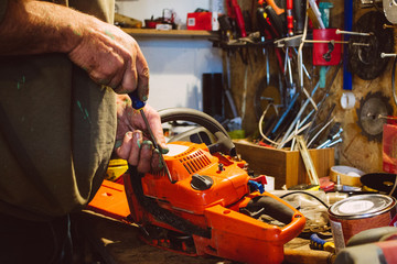 Man repairing a chainsaw