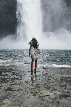 Young woman in front of waterfall