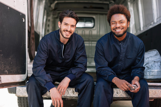Portrait of two work colleges sitting in a van