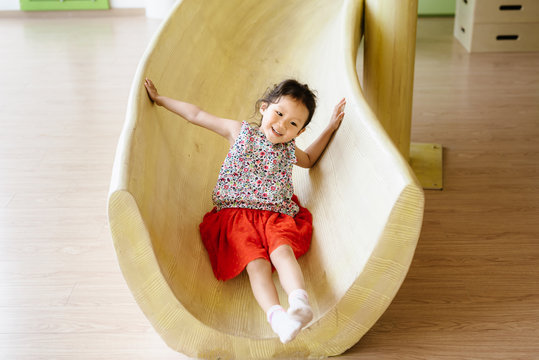 Cute littler girl flying down a slide