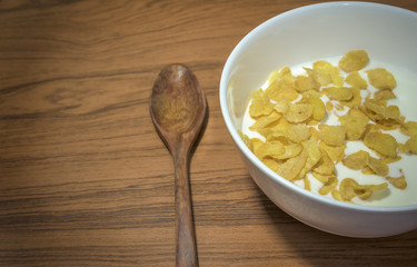 Cornflakes Cereal  with warm milk  in white bowl morning snacks.