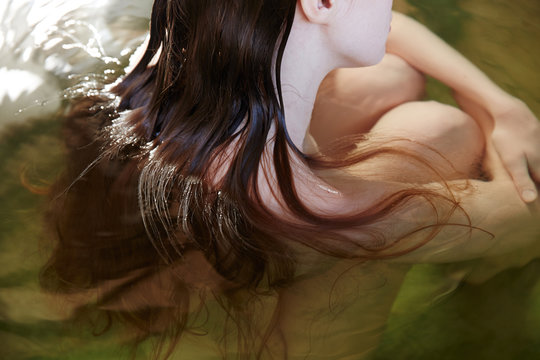 Woman Relaxing In Water At Japanese Spa And Hot Springs 