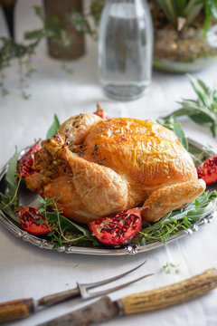 Roast chicken with herbs and pomegranate on a silver