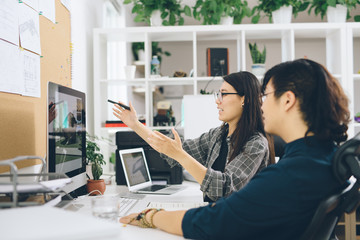 Graphic designers having discussion at work