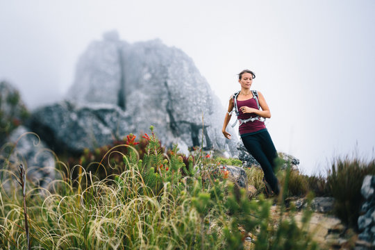 Fit active woman running a mountain trail