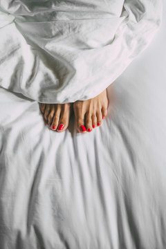 Woman feets in bed