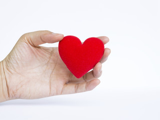 Girl hand holding red heart on white background, valentine concept