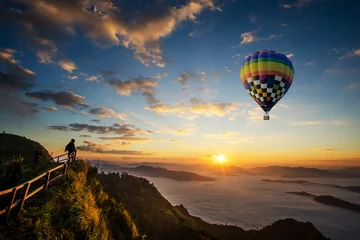 Poster Colorful hot-air balloon flying over the mountain © artpritsadee